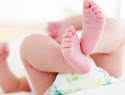 When are kids old enough to help with diapering?
